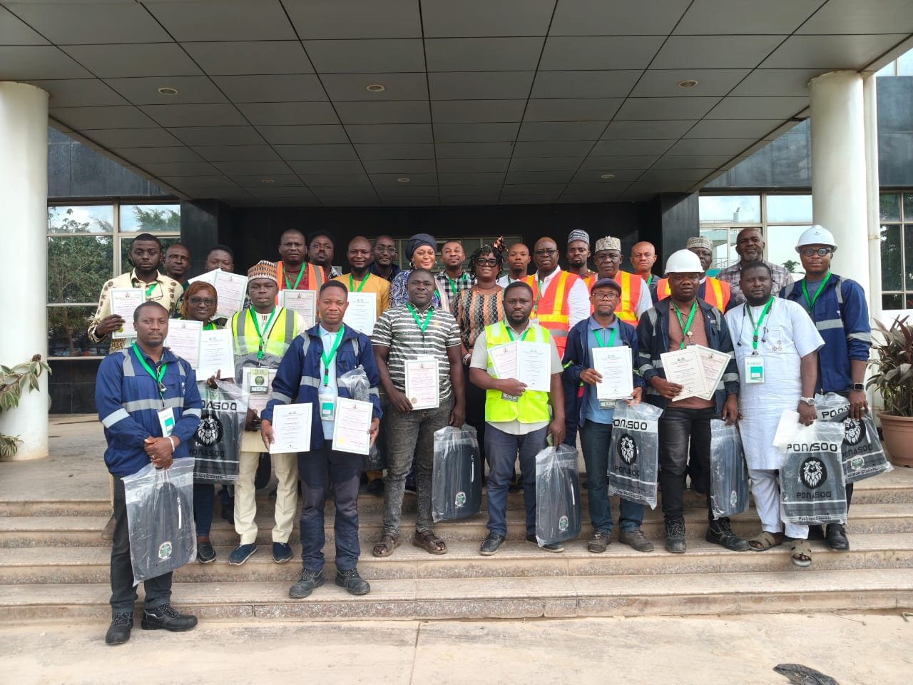 Participants display certificates after the Weights and Measures Department training programme