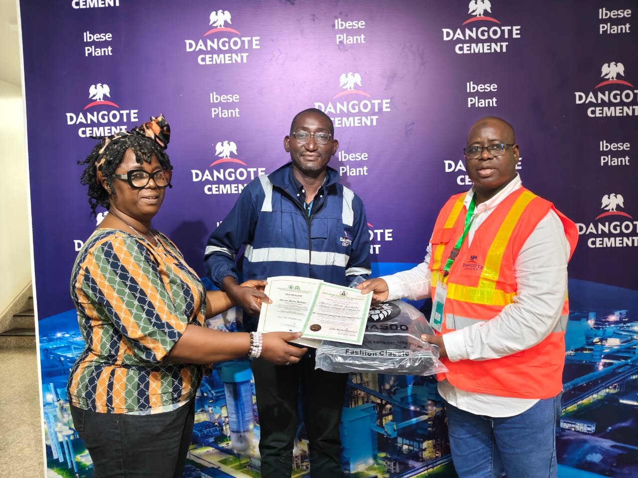 A participant receives a weighbridge competency certificate at the Dangote Cement Ibese Plant training